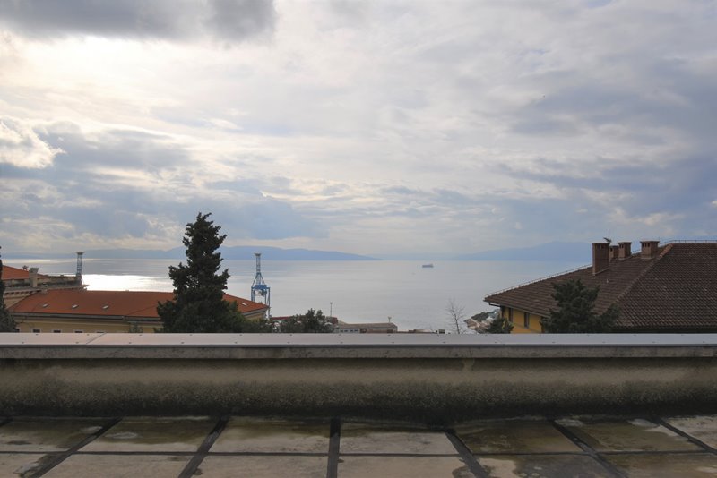 Terrazza sul tetto con vista sui tetti di tegole e sul porto