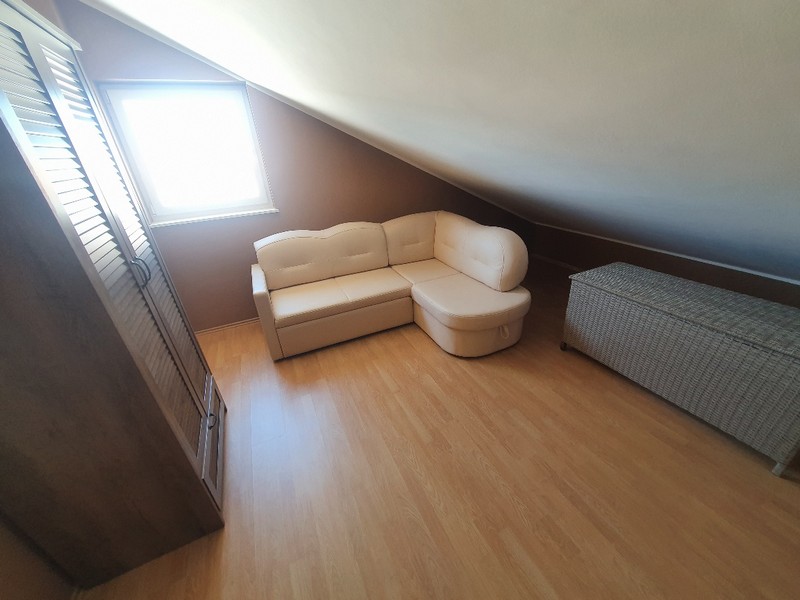 Stanza nel sottotetto con zona seduta e finestra