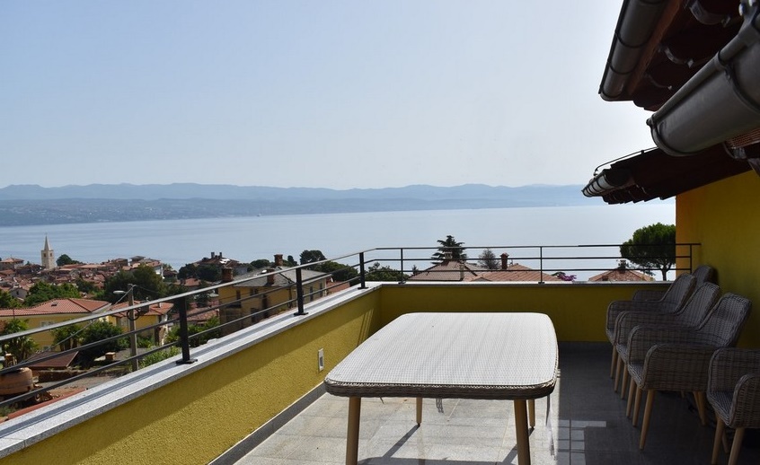 Terrazza sul tetto con tavolo e sedie sopra la baia