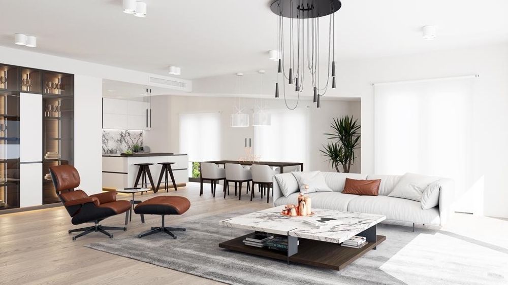 Zona giorno moderna con cucina aperta e poltrona lounge