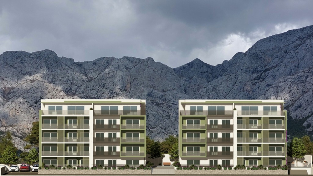 Visualizzazione di due blocchi residenziali davanti alla catena montuosa