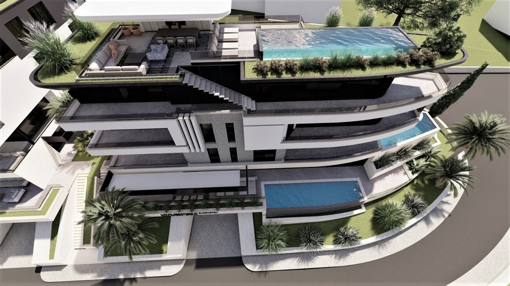 Visualizzazione del complesso dall'alto con piscina sul tetto e terrazze