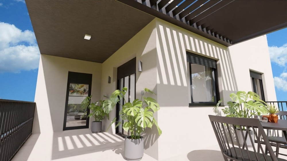 Balcone coperto con piante e sedute, accessibile dall'appartamento.