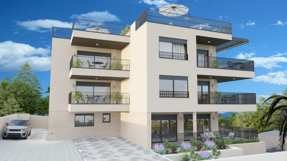 Vista esterna del nuovo edificio residenziale con diversi balconi e terrazze sul tetto.