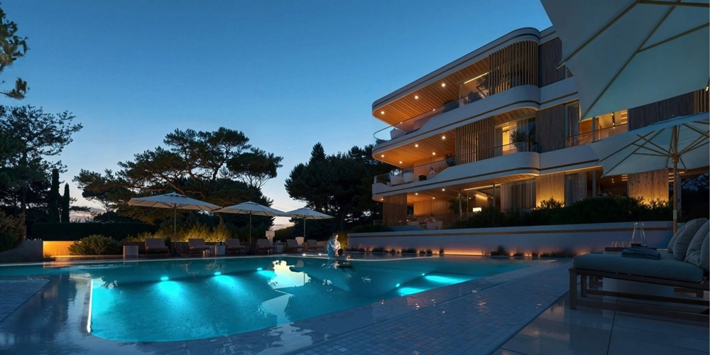 Visualizzazione della piscina illuminata davanti al complesso di sera