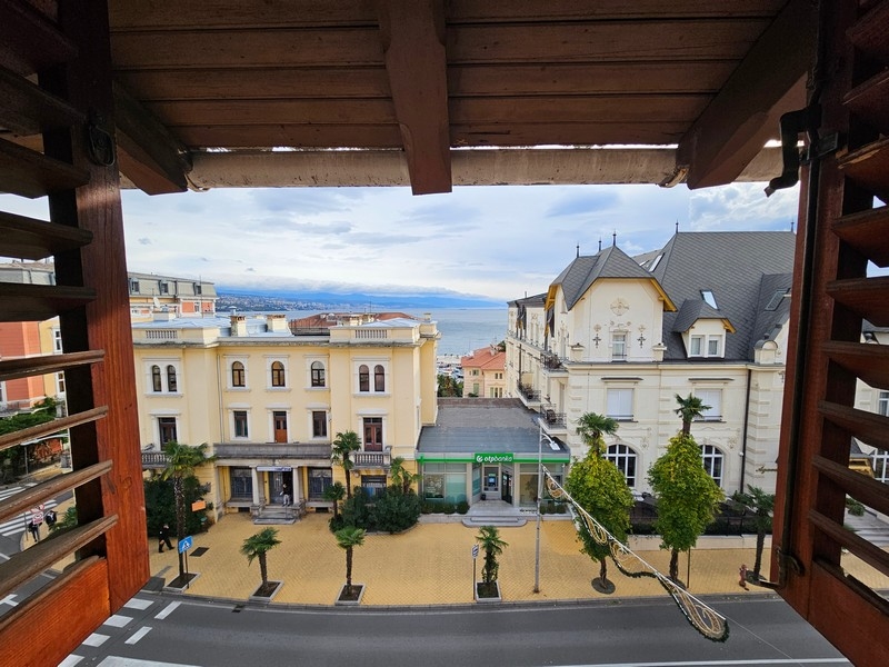 Vista dal balcone sotto il soffitto in legno su vecchi edifici e sul mare