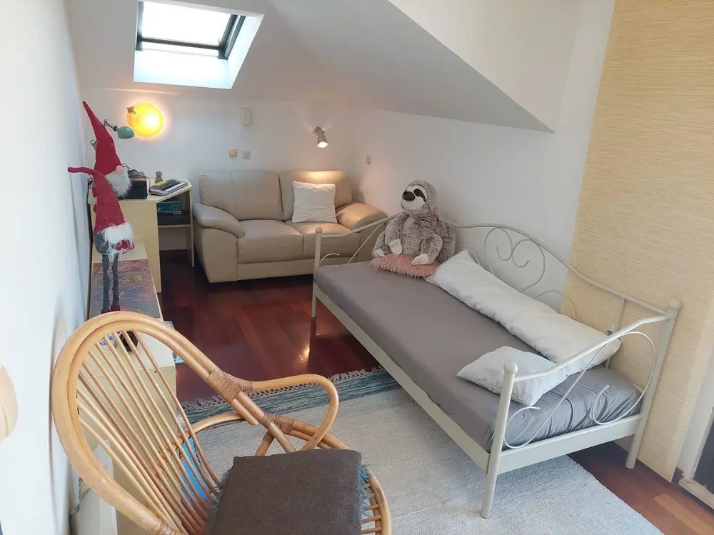 Camera con divano, lucernario, letto e decorazioni