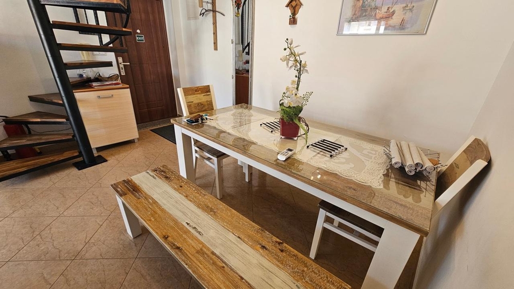 Zona pranzo con tavolo in legno e panca