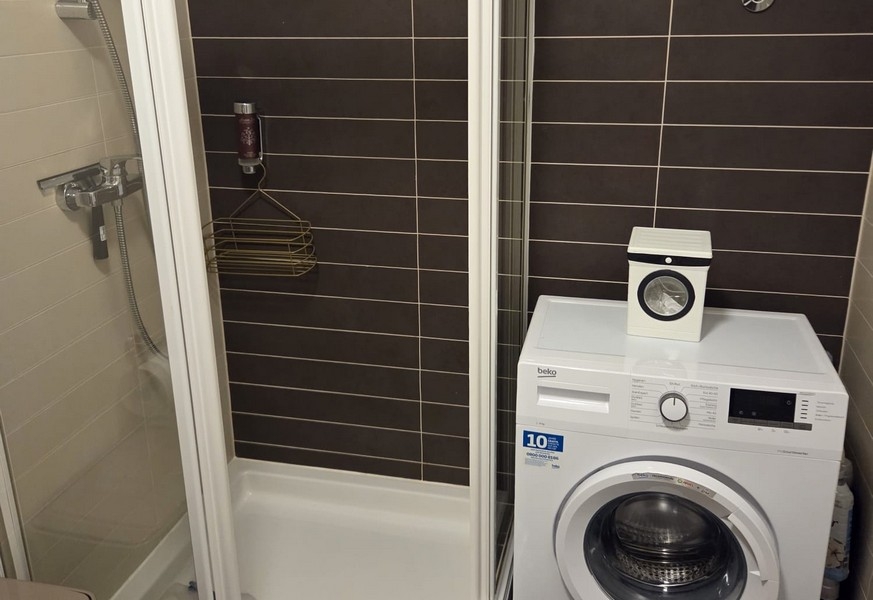 Bagno con doccia e lavatrice