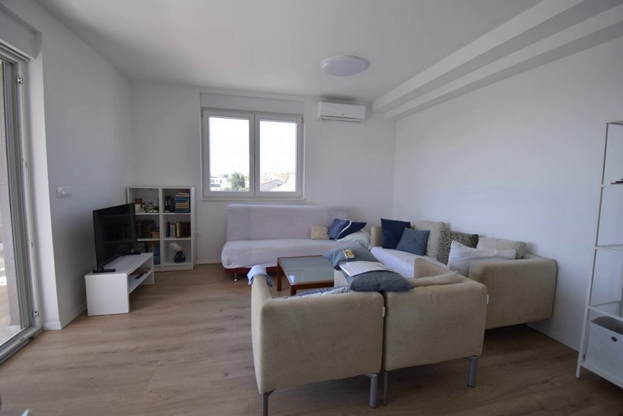 Soggiorno con zona salotto, TV e vetrata
