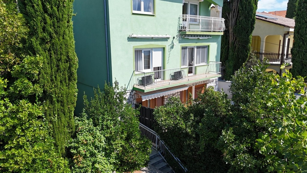 Condominio con balcone e facciata verde