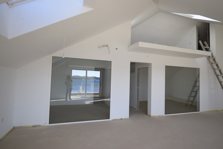 Piano soppalcato e grande vetrata con vista mare
