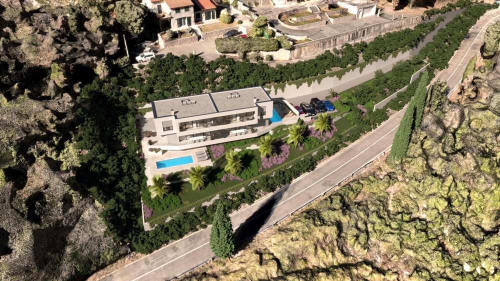 Vista aerea del terreno con edificio e piscina