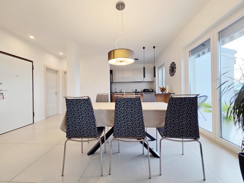 Tavolo da pranzo con sedie a motivi e porta d'ingresso