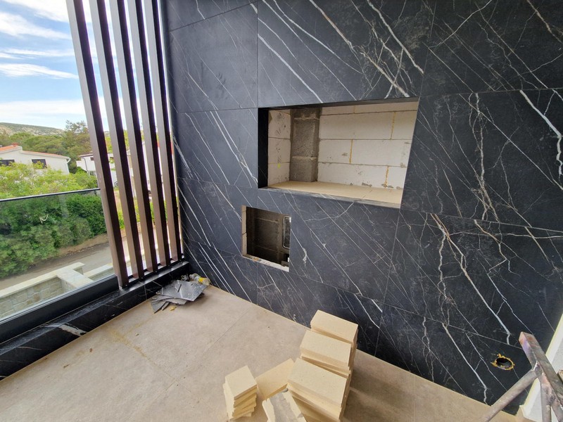 Balcone con parete in pietra scura e nicchia per un barbecue