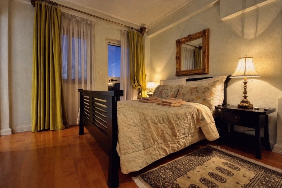 Camera da letto con letto matrimoniale e finestre alte