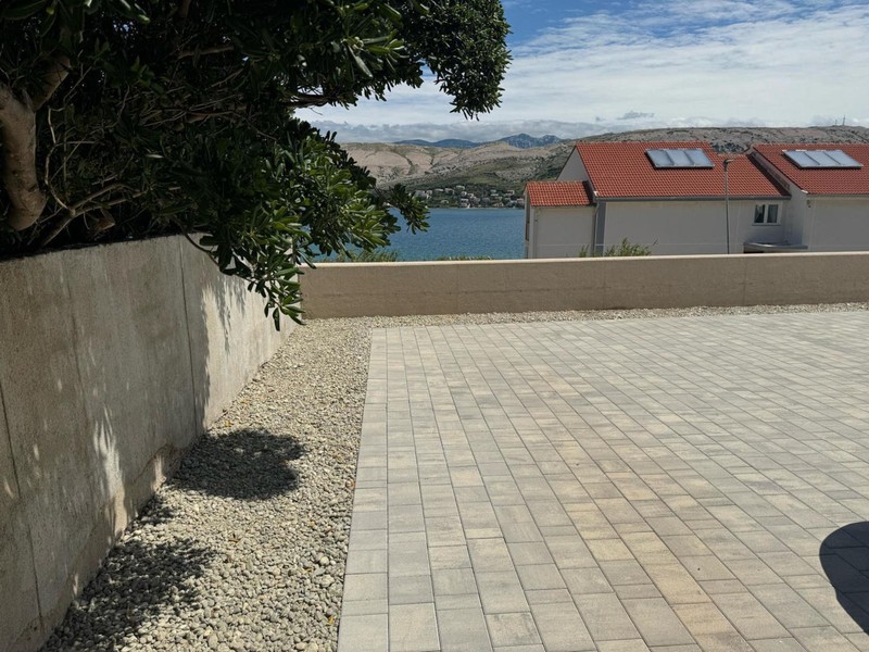 Cortile pavimentato con muretto e vista mare