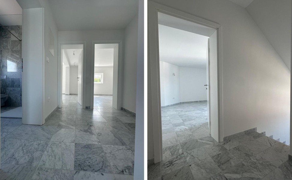 Corridoio con pavimento in marmo e porte per le stanze