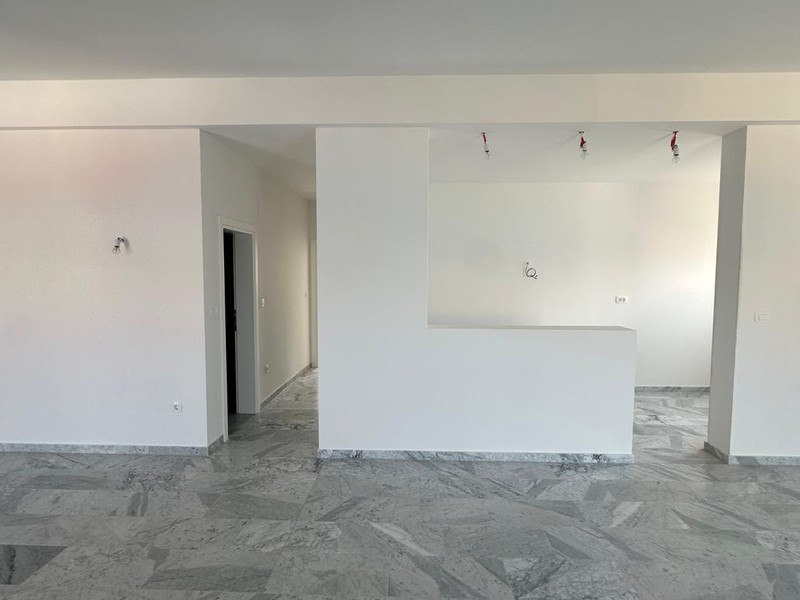 Ampio soggiorno con pavimento in marmo e accesso al terrazzo
