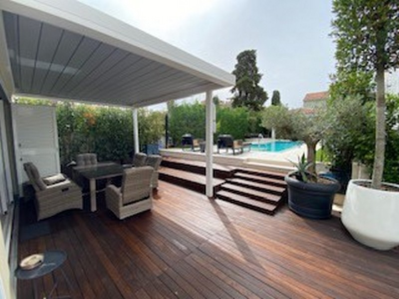 Terrazza in legno semicoperta con vista sulla piscina della villa di lusso in vendita in Istria.