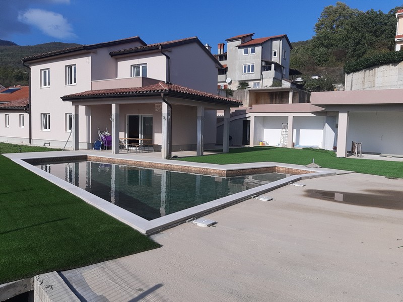 Casa con terrazza coperta e lunga piscina in giardino