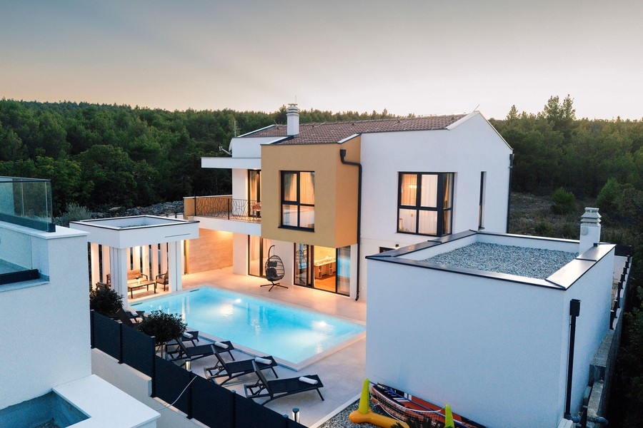 Villa con piscina illuminata al crepuscolo