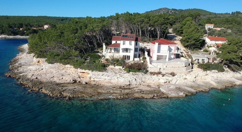 Vista aerea delle case sulla punta rocciosa sopra l'acqua