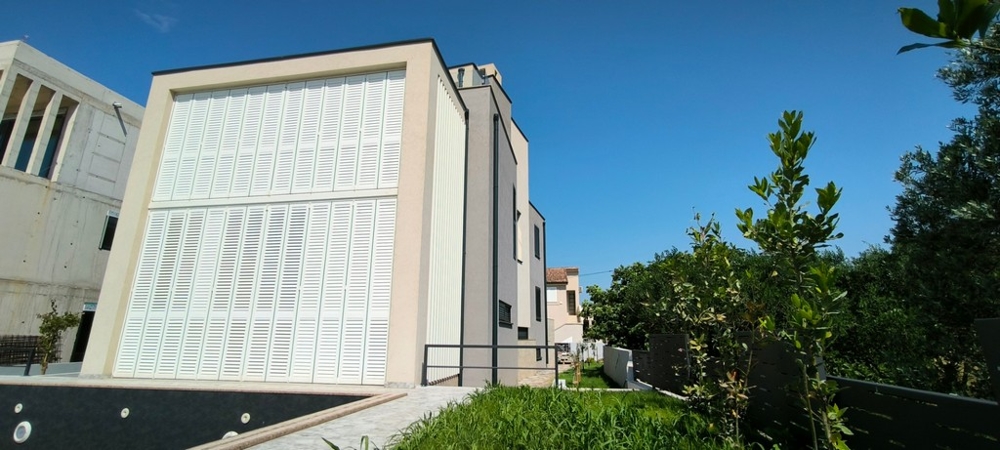 Villa moderna con grandi finestre e ampio giardino