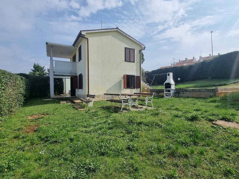 Lato giardino con panche e loggia al piano terra