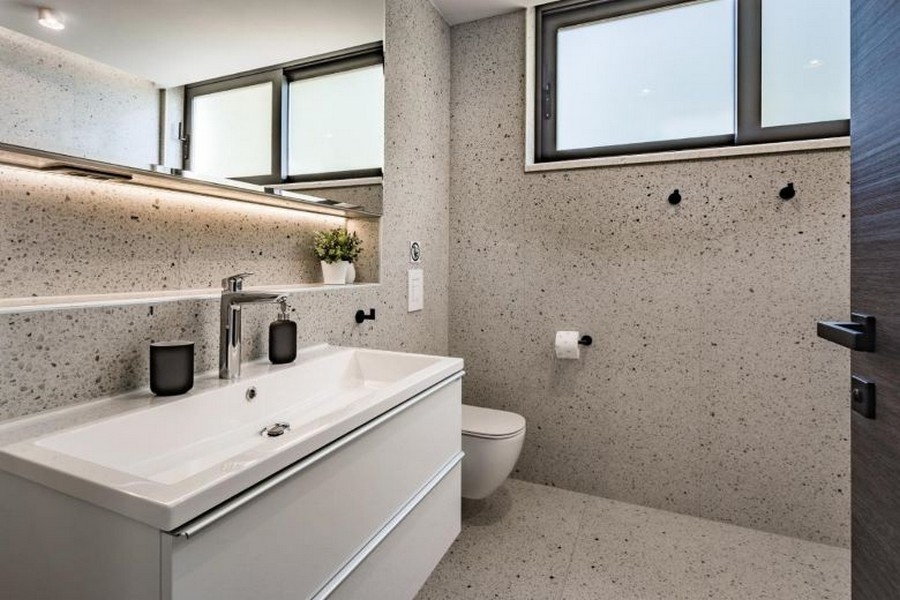 Bagno moderno con ampio piano lavabo e finestra