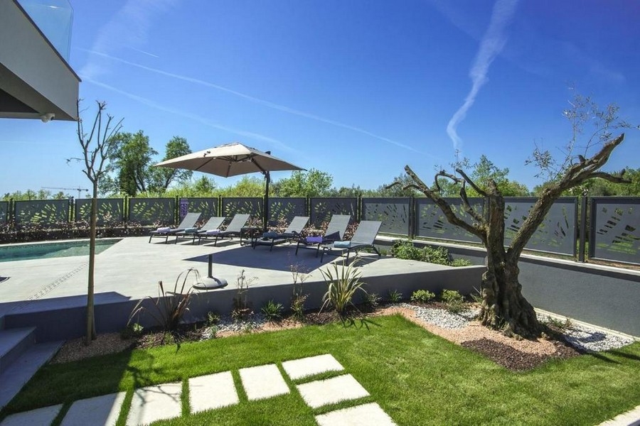Piscina con solarium e giardino