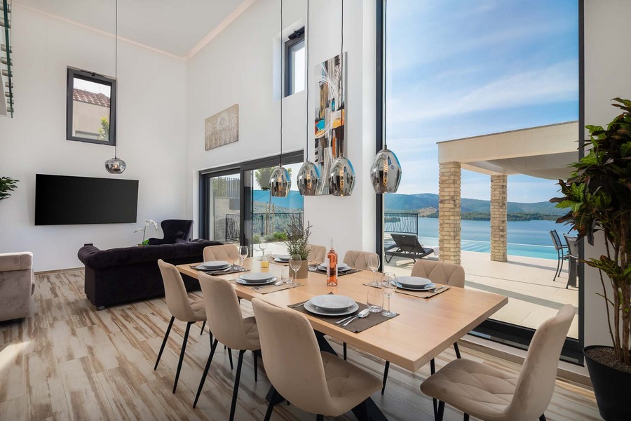 Zona pranzo con grande vetrata e vista sul mare