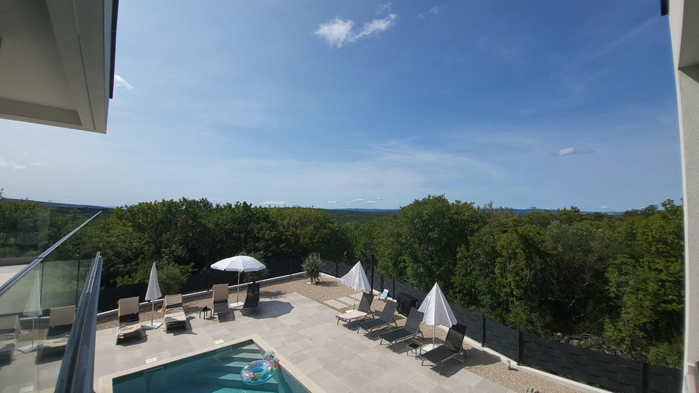 Vista sull'area piscina con lettini prendisole e ombrelloni