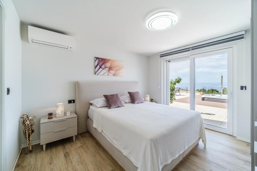 Camera da letto al piano terra con letto matrimoniale e vista mare