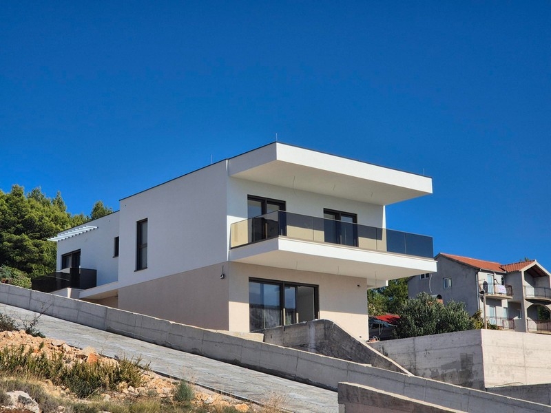 Edificio nuovo bianco con balcone sopra il muro di sostegno in cemento