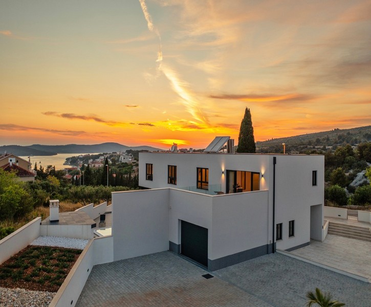 Villa bianca con cipresso al tramonto sulla baia