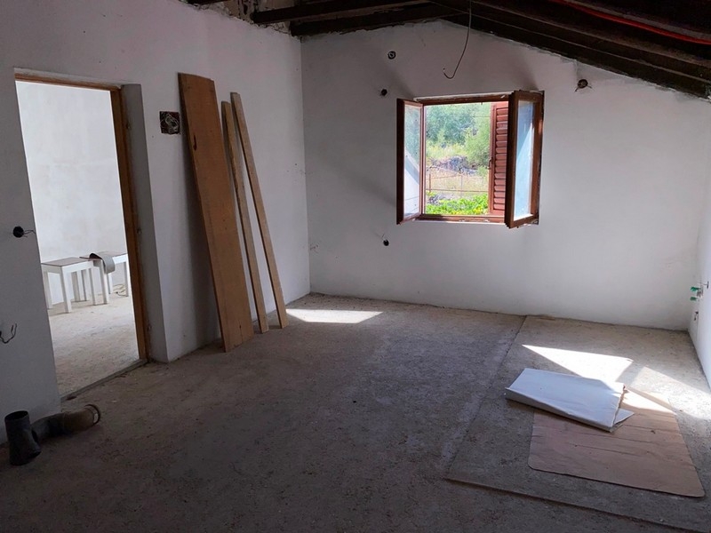 Interno del grezzo al piano superiore con travi del tetto