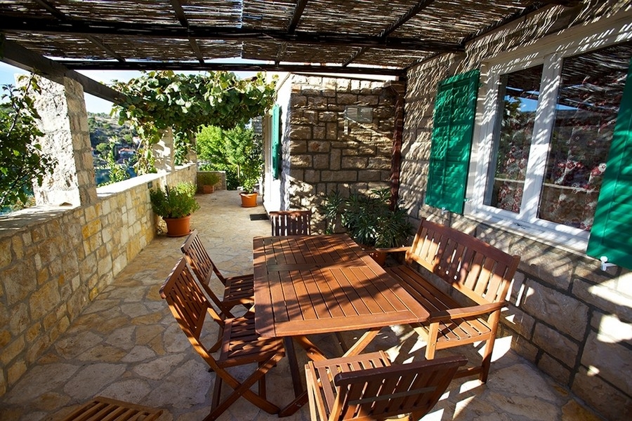 Terrazza mediterranea con pergola e zona salotto