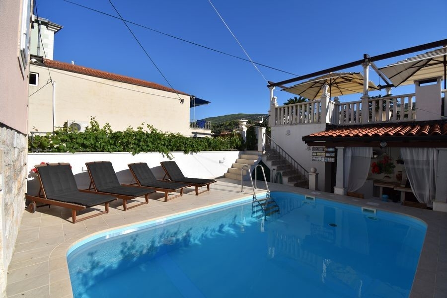 Piscina con solarium e lettini