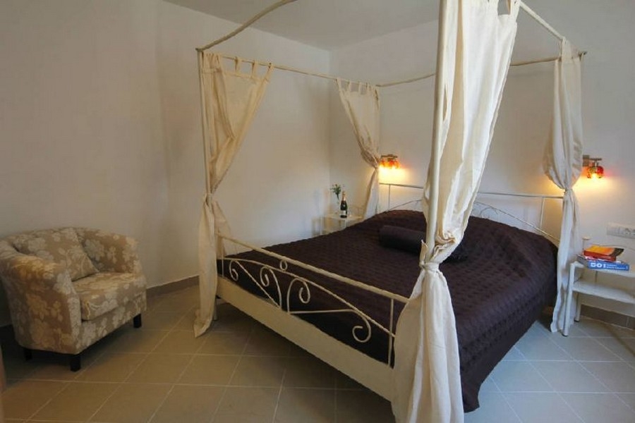 Camera da letto con letto a baldacchino in stile mediterraneo