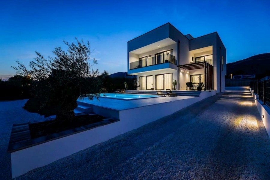 Villa moderna di notte con piscina illuminata