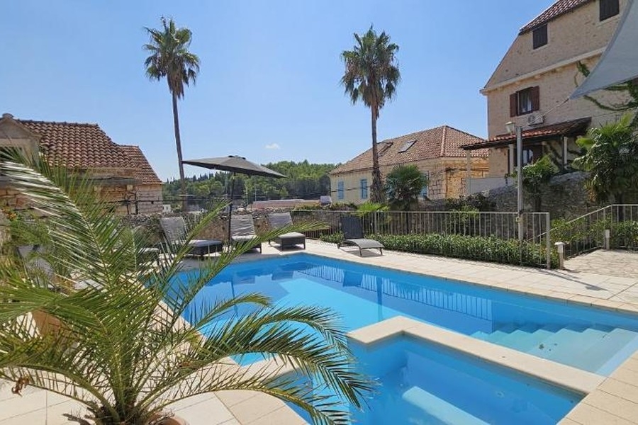 Zona piscina con villa mediterranea in pietra