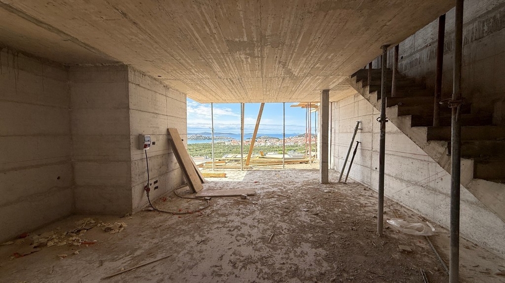 Interno allo stato grezzo con scala e vista mare