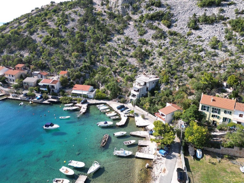 Veduta aerea della baia con barche e casa in prima fila al mare vicino a Senj