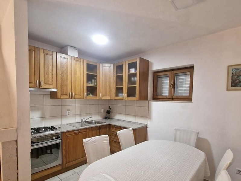 Cucina con ante in legno e tavolo da pranzo
