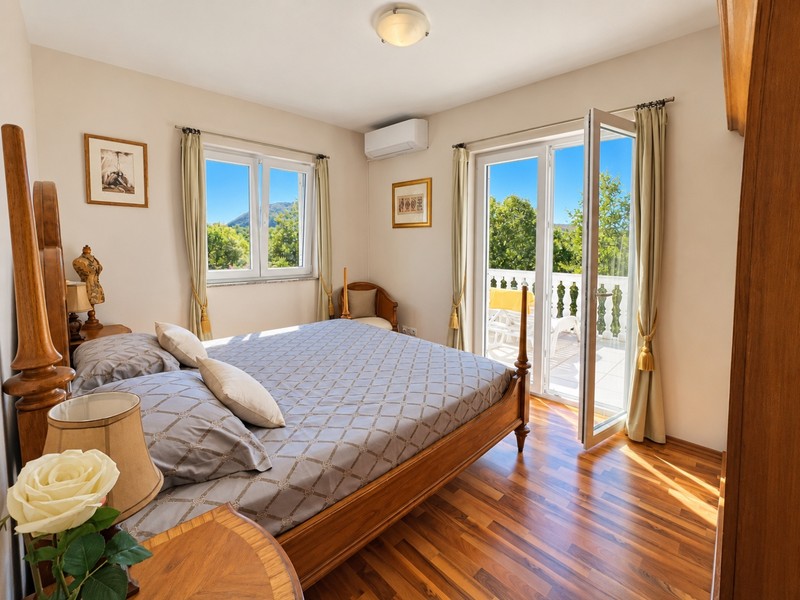 Camera da letto con letto matrimoniale e porta del balcone
