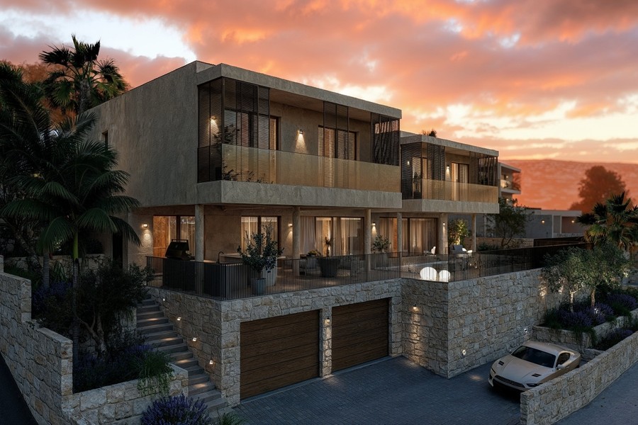 Villa con garage e facciata illuminata la sera