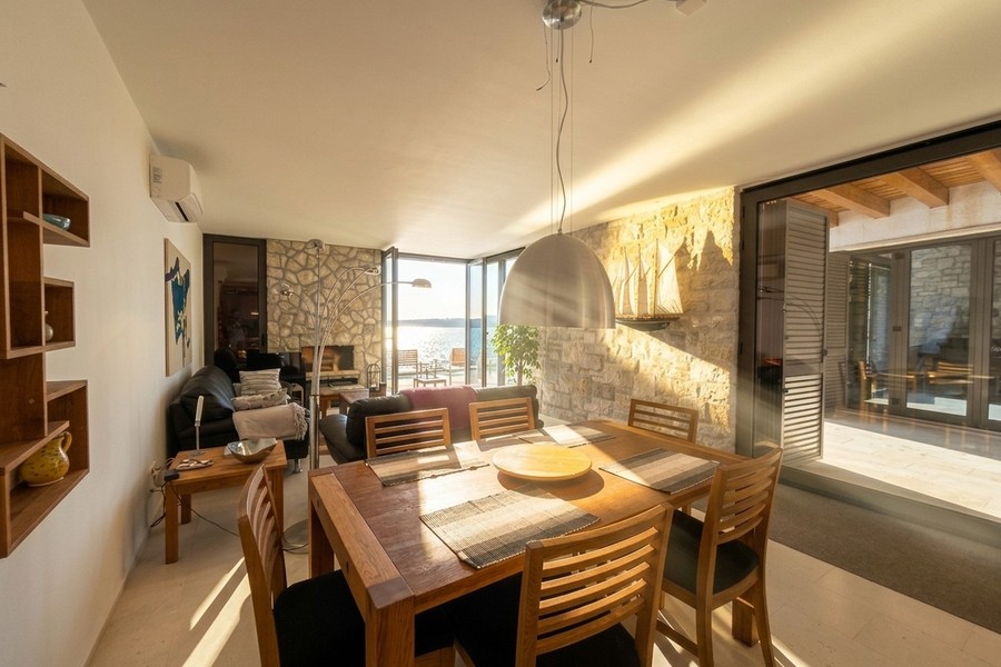 Tavolo da pranzo davanti alla parete vetrata sul mare