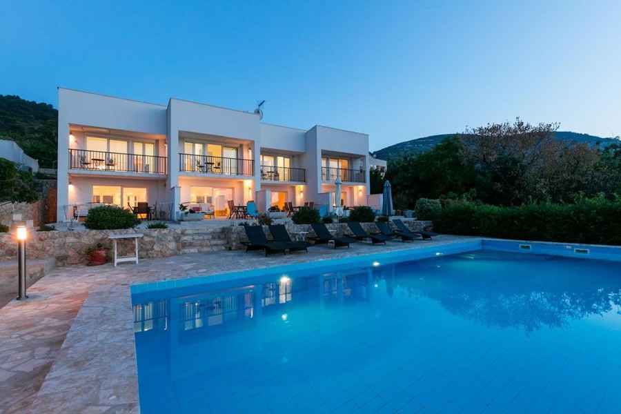 Casa con appartamenti e piscina illuminata la sera